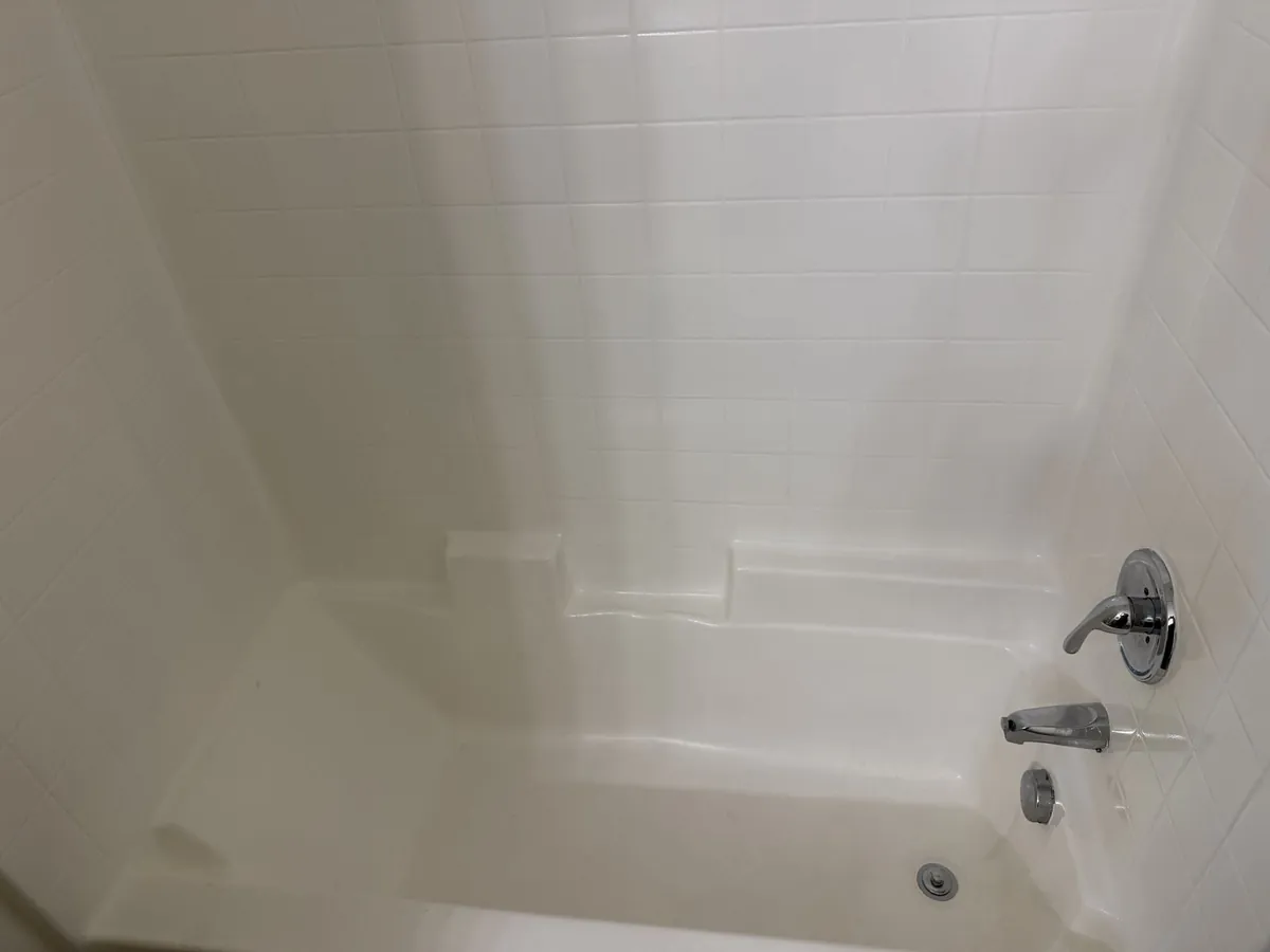 Bathtub after apartment turnover cleaning — sparkling clean