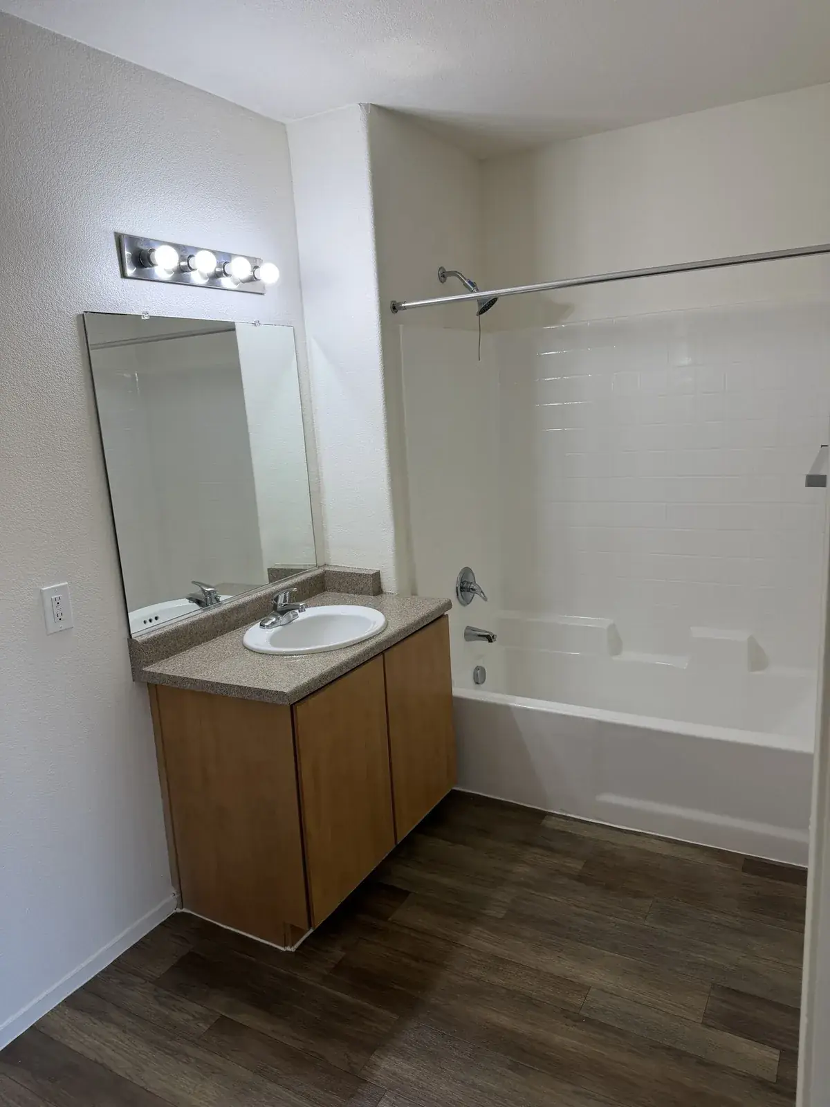 Apartment master bathroom turnover cleaning — clean vanity and bathtub