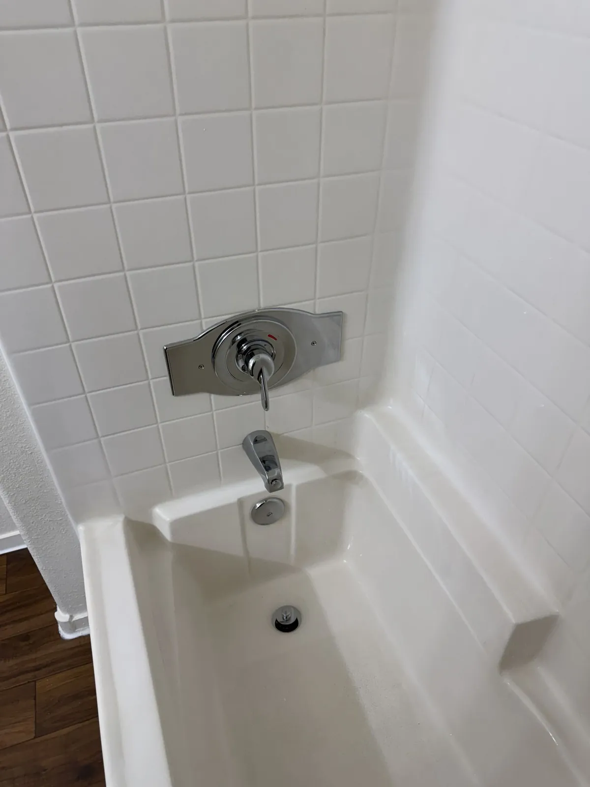 Apartment shower turnover cleaning — clean white tile and fixtures